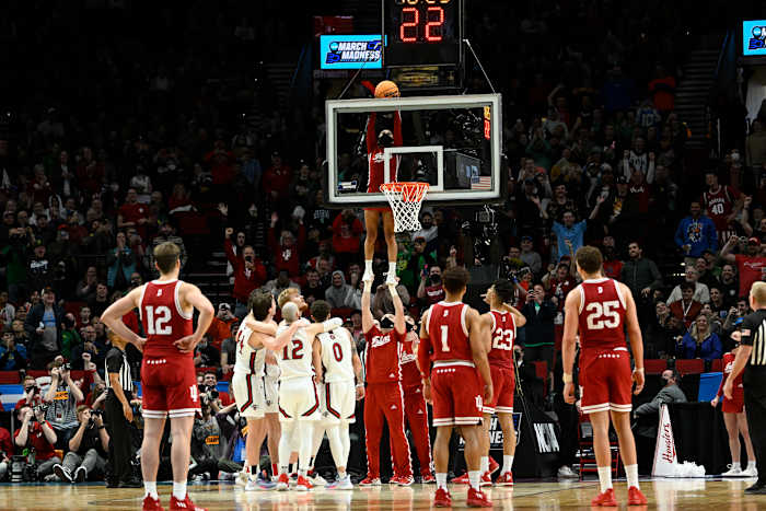 An IU cheerleader retrieves a stuck ball during Indiana's first round game versus Saint Mary's.
